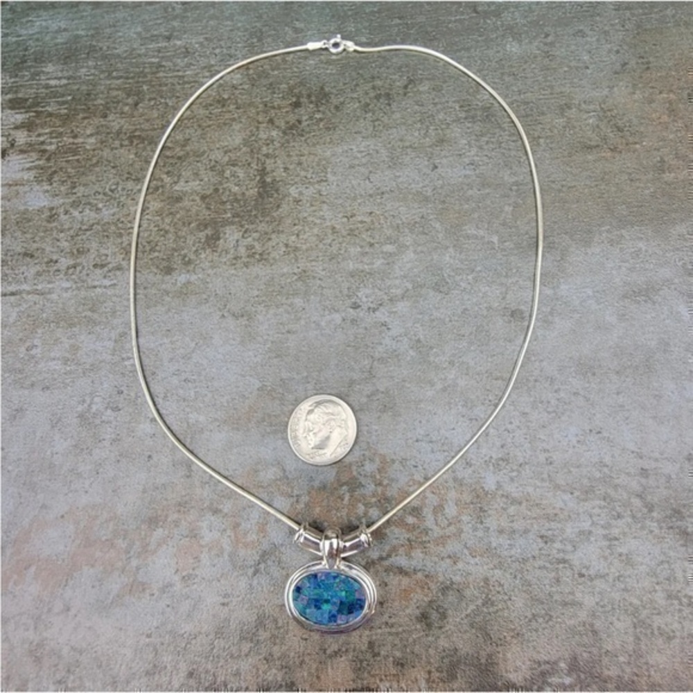 Sterling silver mosaic pendant hangs on necklace